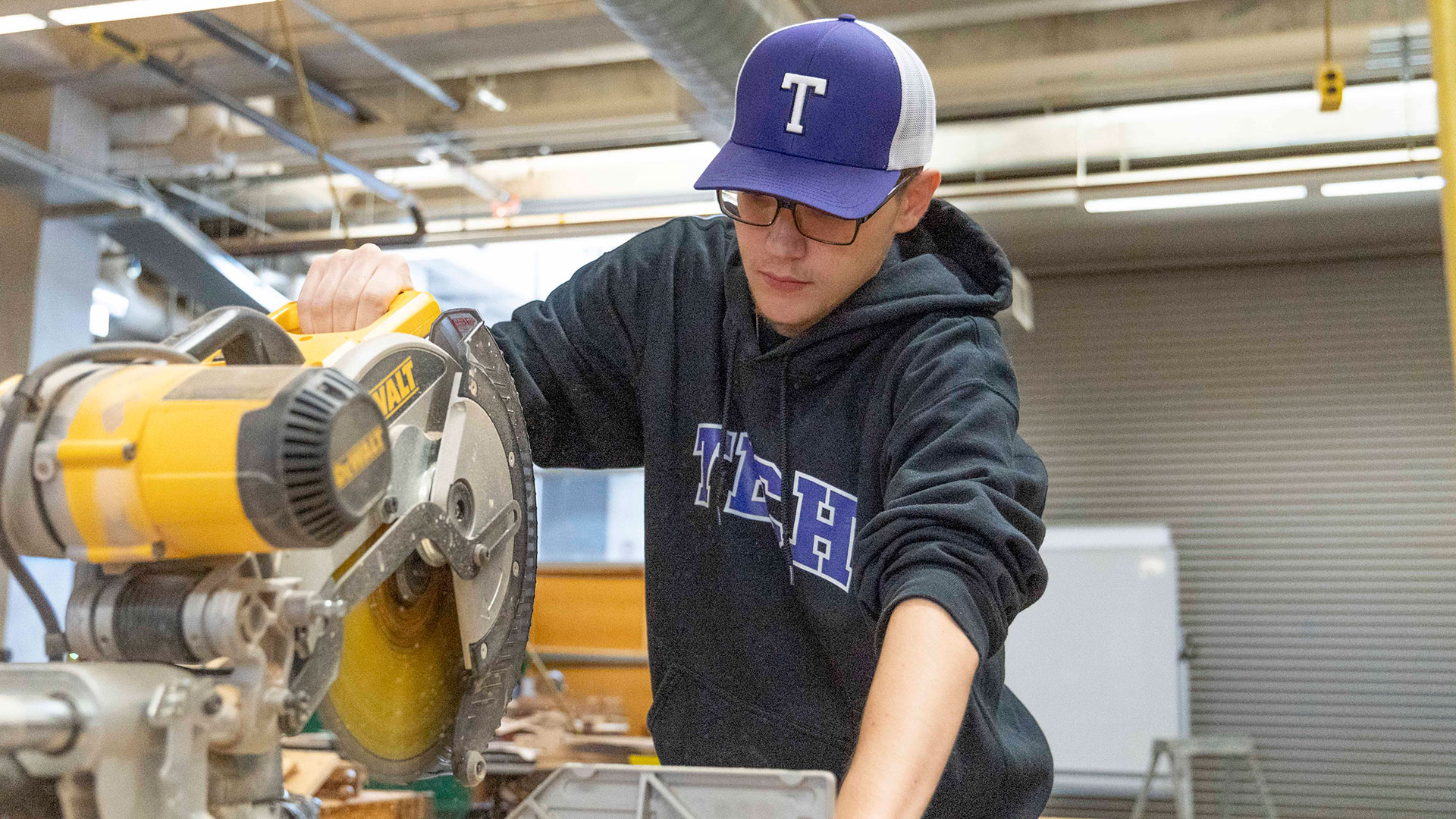 A student using a chop saw.